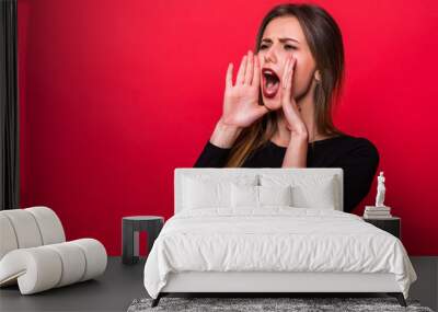 Portrait woman shouting over red background Wall mural